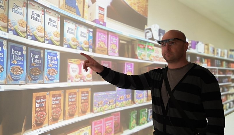 Researcher standing in front of Perceptual Experience Laboratory Screen