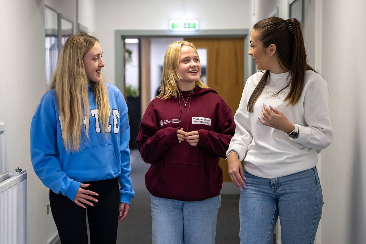 3 students walking in corridor