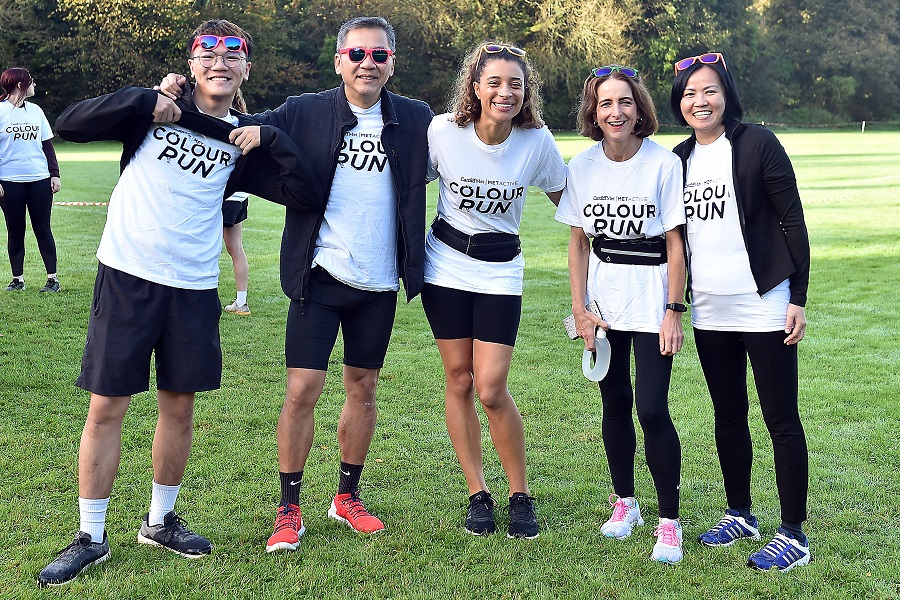 Adrian Ng and his family stand in a field wearing matching Colour Run t-shirts