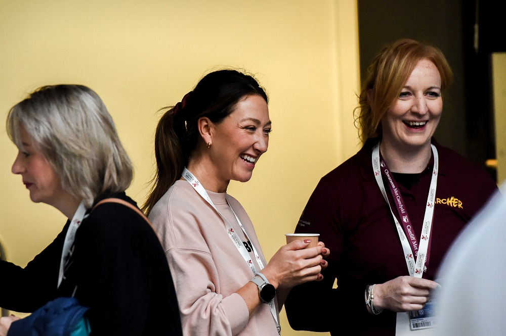 Two ArcHER attendees smiling and laughing