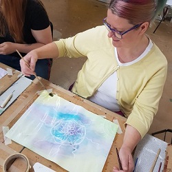 Participant painting a design