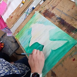 Participant painting a fish