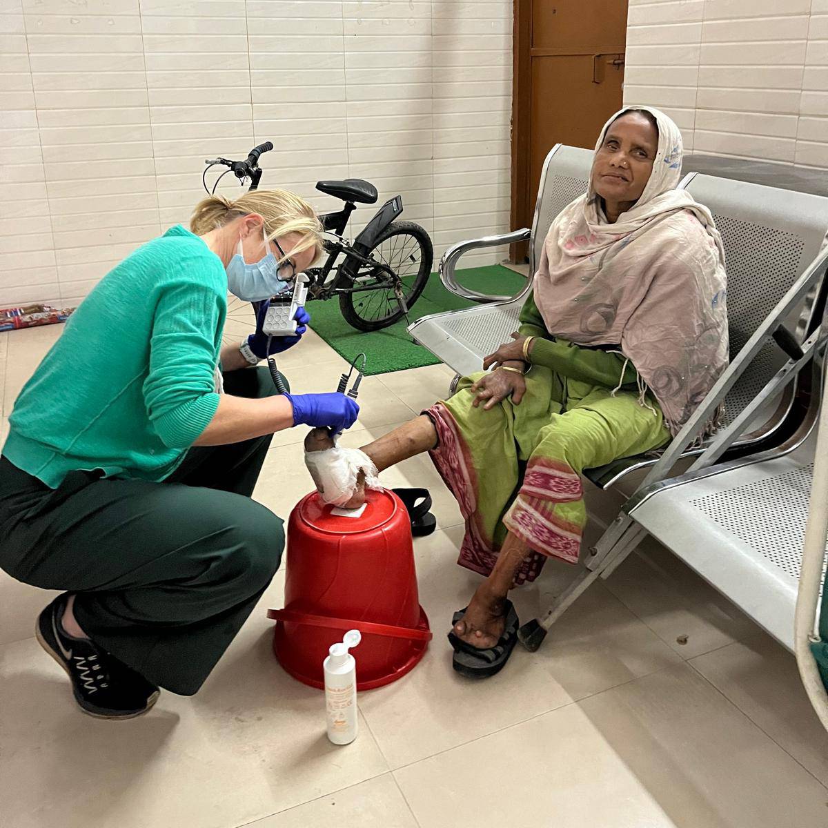 Woman examining a patient's foot