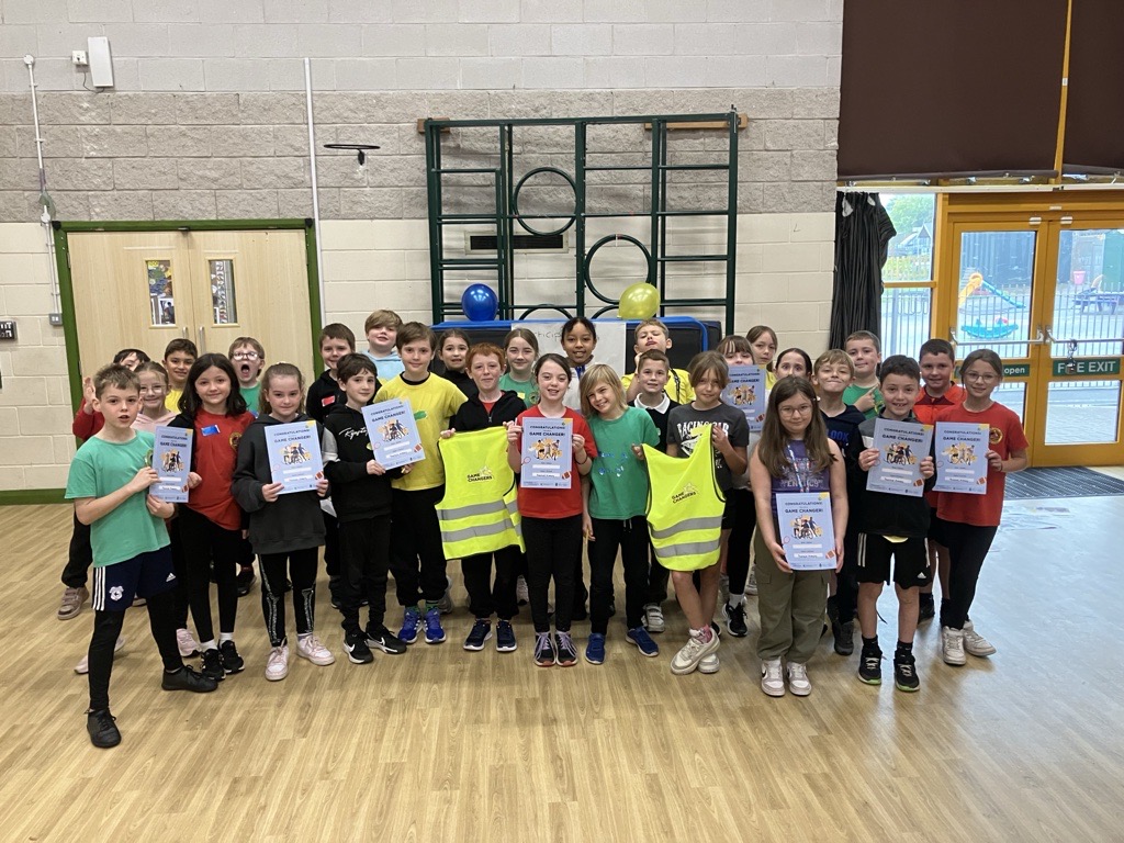 Group of school children holding certificates