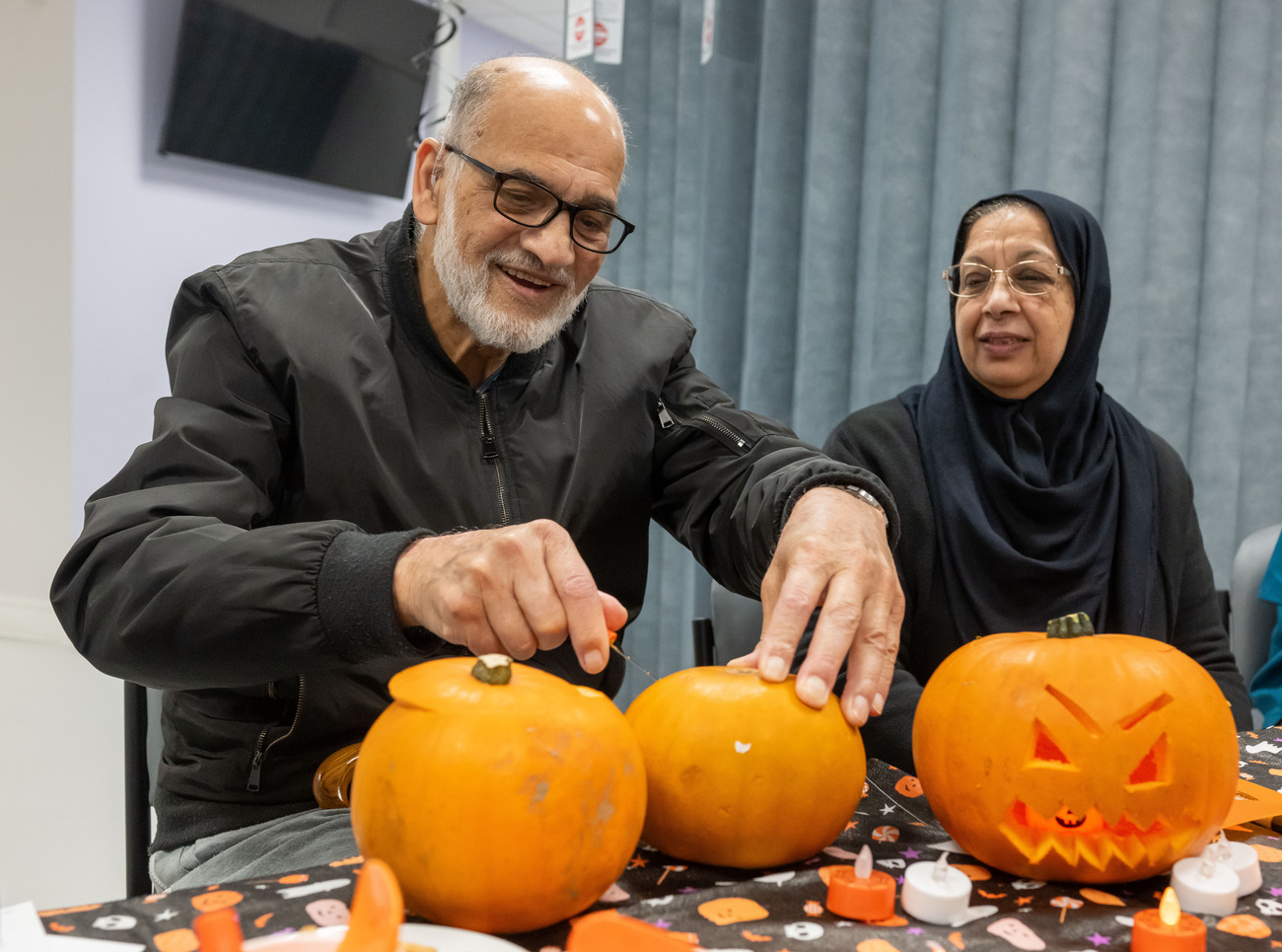 Mohamed Ismail with his wife cutting pumpkins for halloween